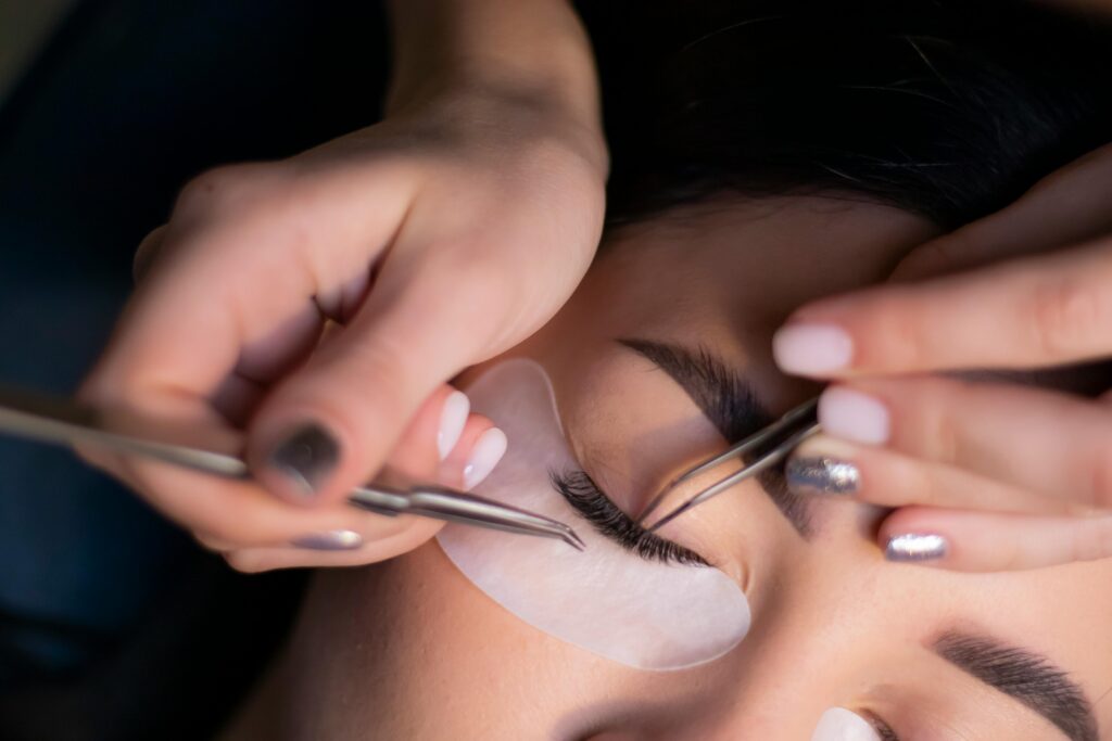 pexels photo 8554941 8554941 Detailed view of a beautician applying eyelash extensions to a woman's eyes.